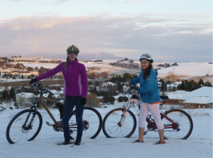 Jaime Brush with Isabella on a snowy bike ride, with Moscow Mountain in the background.