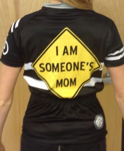 Bike jersey with yellow caution diamond reading "I Am Somebody's Mom" on back, from Carytown Bicycles http://www.carytownbikes.com/
