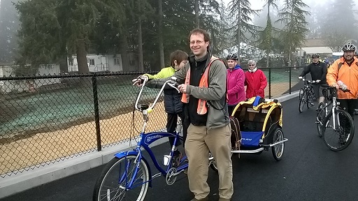 Dad with son, bike pulling trailer, and others at dedication of final phase of Bridging the Gap project on the Chehalis-Western Trail, Olympia, WA, Dec. 13, 2014