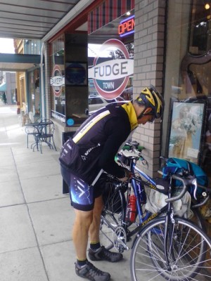 Rider with two bicycles and panniers outside Snohomish Bakery Creations, Snohomish, WA