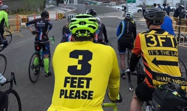 Bike riders wearing 3 feet shirts