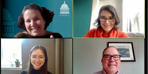 Four people smiling on a Zoom screen